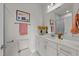 Bright bathroom featuring white cabinetry, a marble countertop, and a glass-enclosed shower at 1400 Gathering Park Cir # 202, Cary, NC 27519