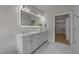 Bright bathroom with double vanity, illuminated mirror, and access to walk-in closet at 1400 Gathering Park Cir # 202, Cary, NC 27519