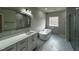 Bathroom featuring double sinks, soaking tub, and elegant tile finishes at 1400 Gathering Park Cir # 202, Cary, NC 27519