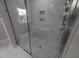 Modern bathroom with glass shower, marble walls, and built-in bench at 1400 Gathering Park Cir # 202, Cary, NC 27519