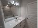 Updated bathroom with a wide vanity, quartz countertop and marble style tiles at 1400 Gathering Park Cir # 202, Cary, NC 27519