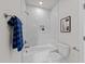 Bathroom featuring a tub and shower combination, with tiled walls and modern fixtures at 1400 Gathering Park Cir # 202, Cary, NC 27519