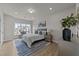 Bright bedroom with large window, accent chair, and modern decor at 1400 Gathering Park Cir # 202, Cary, NC 27519