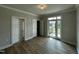 Bedroom with hardwood floors, bathroom access, and a glass door to the balcony at 1400 Gathering Park Cir # 202, Cary, NC 27519