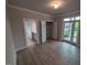 Bedroom featuring wood floors, closet, bathroom access, and a balcony at 1400 Gathering Park Cir # 202, Cary, NC 27519