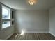 A quaint bedroom area with hardwood flooring, decorative lighting, and a charming window at 1400 Gathering Park Cir # 202, Cary, NC 27519