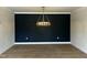 Modern dining room features a stylish black accent wall and contemporary chandelier at 1400 Gathering Park Cir # 202, Cary, NC 27519
