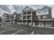 Brick exterior of building with double balconies and ample parking spaces at 1400 Gathering Park Cir # 202, Cary, NC 27519