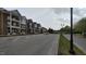 Exterior street view of a brick apartment building with green space at 1400 Gathering Park Cir # 202, Cary, NC 27519