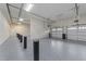 A spacious garage with epoxy flooring, equipped with multiple garage doors and ample room at 1400 Gathering Park Cir # 202, Cary, NC 27519