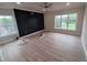 Large open living room featuring hardwood floors, recessed lighting, and an accent wall at 1400 Gathering Park Cir # 202, Cary, NC 27519