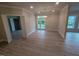 Open-concept living room with hardwood floors, recessed lighting, and patio access at 1400 Gathering Park Cir # 202, Cary, NC 27519