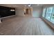 Spacious open-concept living room with hardwood floors, recessed lighting, and accent wall at 1400 Gathering Park Cir # 202, Cary, NC 27519