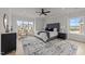 Serene main bedroom with a cozy bed, sitting area, large windows, and ample natural light at 1400 Gathering Park Cir # 202, Cary, NC 27519