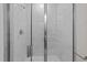 Modern shower with a glass door and marble-patterned tile surround at 1400 Gathering Park Cir # 202, Cary, NC 27519