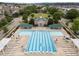 Aerial view of a community pool with a bath house and lounge area at 1400 Gathering Park Cir # 202, Cary, NC 27519