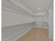 Spacious walk-in closet with wood floor, shelving and ample storage space at 1400 Gathering Park Cir # 202, Cary, NC 27519
