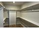 Spacious walk-in closet with multiple shelves and wooden closet rods at 1400 Gathering Park Cir # 202, Cary, NC 27519
