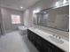 Bathroom featuring double vanity, modern soaking tub, and large mirror at 1400 Gathering Park Cir # 204, Cary, NC 27519
