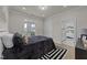 Comfortable bedroom with balcony access, neutral colors, and ensuite bathroom entrance at 1400 Gathering Park Cir # 204, Cary, NC 27519