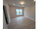 Well-lit bedroom with plank flooring, neutral walls and a large window offering scenic neighborhood views at 1400 Gathering Park Cir # 204, Cary, NC 27519