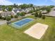 Aerial view of tennis and volleyball courts within a neighborhood, promoting active community lifestyle at 1400 Gathering Park Cir # 204, Cary, NC 27519