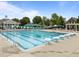 Community pool featuring lap lanes, diving blocks, and surrounding trees at 1400 Gathering Park Cir # 204, Cary, NC 27519