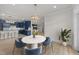 Open dining area featuring modern table set, views into kitchen, and plenty of natural light at 1400 Gathering Park Cir # 204, Cary, NC 27519