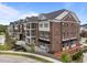 Stunning three-story brick condo building with balconies, awnings, and manicured landscaping at 1400 Gathering Park Cir # 204, Cary, NC 27519