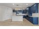 Kitchen featuring an island, stainless steel appliances, blue cabinetry, and stylish light fixture at 1400 Gathering Park Cir # 204, Cary, NC 27519