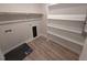 A well-organized laundry room with built-in shelving, providing convenience and ample storage space at 1400 Gathering Park Cir # 204, Cary, NC 27519
