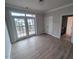 Bedroom featuring wood floors, natural light, french doors to a balcony, and access to the bathroom at 1400 Gathering Park Cir # 204, Cary, NC 27519
