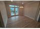 Bright living room with hardwood floors, light walls, and view through glass patio doors at 1400 Gathering Park Cir # 204, Cary, NC 27519