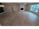 Living room with hardwood floors, fireplace, large window, and neutral walls at 1400 Gathering Park Cir # 204, Cary, NC 27519