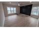 Living room featuring wood floors, natural light, and black accent wall at 1400 Gathering Park Cir # 204, Cary, NC 27519