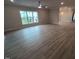 Spacious living room with wood floors, ceiling fan, large window, and neutral walls at 1400 Gathering Park Cir # 204, Cary, NC 27519