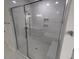 Bathroom featuring glass enclosed shower, marble tile, and built in bench at 1400 Gathering Park Cir # 204, Cary, NC 27519