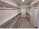Spacious walk-in closet featuring custom shelving and hardwood flooring providing ample storage space at 1400 Gathering Park Cir # 204, Cary, NC 27519