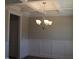 A dining room featuring modern wainscotting, a box ceiling, and a chandelier light fixture at 1415 Reading Ct # 77Kl, Burlington, NC 27217