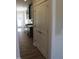 Hallway view of a modern kitchen with stainless steel appliances and black cabinets at 1415 Reading Ct # 77Kl, Burlington, NC 27217