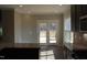 An open concept kitchen with granite countertops, stainless steel appliances, and access to a back deck at 1415 Reading Ct # 77Kl, Burlington, NC 27217