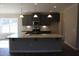 A kitchen featuring gray cabinets, a large island, and stainless steel appliances at 1415 Reading Ct # 77Kl, Burlington, NC 27217