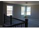 Well-lit loft featuring plush carpeting, modern trim, and multiple windows at 1415 Reading Ct # 77Kl, Burlington, NC 27217