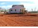A view of the rear of a new construction house with a small back porch and light-colored siding at 1415 Reading Ct # 77Kl, Burlington, NC 27217