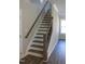 Elegant staircase featuring wooden steps, wrought iron spindles, and decorative trim at 1415 Reading Ct # 77Kl, Burlington, NC 27217