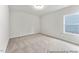 Bedroom featuring plush carpet and a window with natural light at 143 Benson Village Dr # 77P, Benson, NC 27504