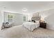Spacious main bedroom with a chair and large windows, offering comfort and style at 143 Benson Village Dr # 77P, Benson, NC 27504
