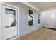 Cozy back porch with light-blue siding, white trim, and a wooden deck with an entrance door at 1662 Piney Fls Dr, Wendell, NC 27591