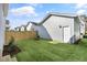 The backyard features new grass, a small deck, and a wooden fence at 1662 Piney Fls Dr, Wendell, NC 27591