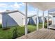 Backyard view of a house featuring grass with a small deck and white posts at 1662 Piney Fls Dr, Wendell, NC 27591